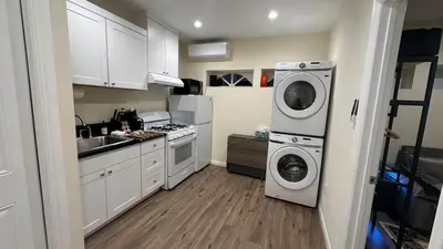 a kitchen with a washing machine and a washer at 2B2B quiet comfy home in Hacienda Heights