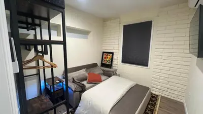 a small bedroom with a bed and a shelf at 2B2B quiet comfy home in Hacienda Heights