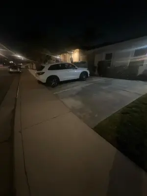 a white car parked in a driveway at night at 2B2B quiet comfy home in Hacienda Heights