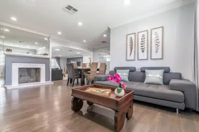 a living room with a couch and a table at Tranquil Poolside Oasis with BBQ and Serene Ambiance in North Hollywood