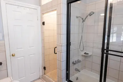 a bathroom with a shower with a glass door at Tranquil Poolside Oasis with BBQ and Serene Ambiance in North Hollywood
