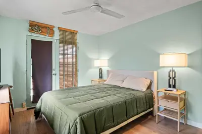 a bedroom with a bed and a ceiling fan at Steps to Venice Beach Vintage Venice Retreat in Los Angeles