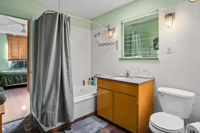 a bathroom with a toilet and a sink and a shower at Steps to Venice Beach Vintage Venice Retreat in Los Angeles