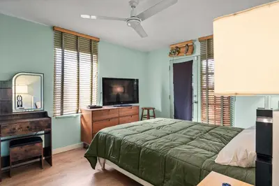 a bedroom with a bed and a flat screen tv at Steps to Venice Beach Vintage Venice Retreat in Los Angeles