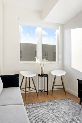 a living room with a couch and two tables at Bright Studio on Sunset Blvd, Free Parking, Gym, and Pool in Los Angeles