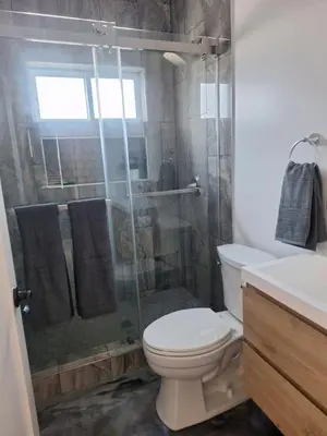 a bathroom with a toilet and a glass shower at Azusa in Azusa