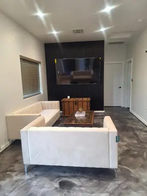 a living room with a couch and a flat screen tv at Azusa in Azusa