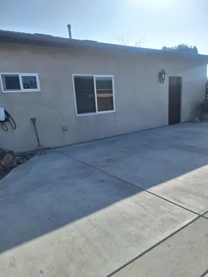 a large white building with a door and two windows at Azusa in Azusa