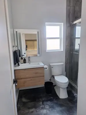 a bathroom with a toilet and a sink and a shower at Beautiful and cosy home in Azusa