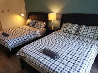 two beds sitting next to each other in a room at Beverly Hills Studios in Los Angeles