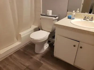 a white bathroom with a toilet and a sink at Beverly Hills Studios in Los Angeles
