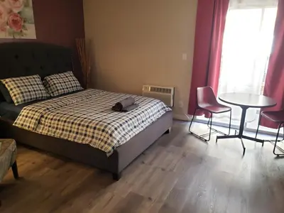 a bedroom with a bed and a table and chairs at Beverly Hills Suite with Balcony in Los Angeles