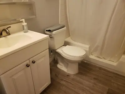a bathroom with a toilet and a sink and a shower at Beverly Hills Suite with Balcony in Los Angeles