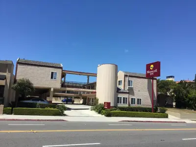 a sign for a gas station next to a street at Moonlite Inn in Redondo Beach