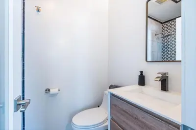 a bathroom with a toilet and a sink at Maison on the Beach in Los Angeles