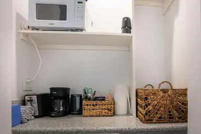 a microwave sitting on a shelf in a kitchen at Maison on the Beach in Los Angeles