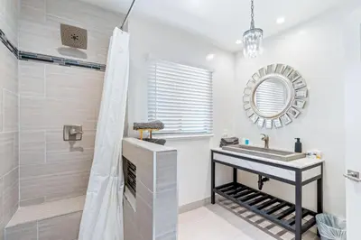 a bathroom with a sink and a shower at Maison on the Beach in Los Angeles
