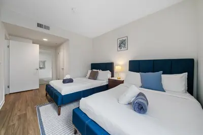 a bedroom with two beds and a room with at Location Walk to the beach Chic Condo! in Los Angeles