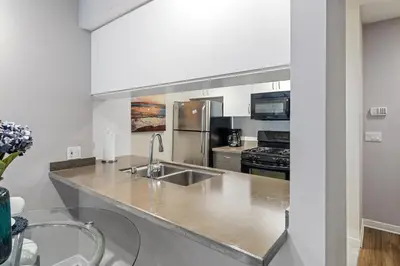 a kitchen with a sink and a stove at Location Walk to the beach Chic Condo! in Los Angeles