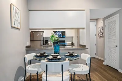 a dining room with a table and chairs and a kitchen at Location Walk to the beach Chic Condo! in Los Angeles