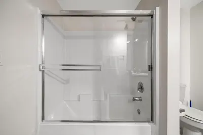 a shower with a glass door in a bathroom at Location Walk to the beach Chic Condo! in Los Angeles