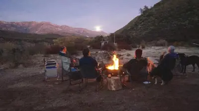 a group of people sitting around a camp fire at Ojai Wilderness Off-The-Grid Sespe House in Ojai
