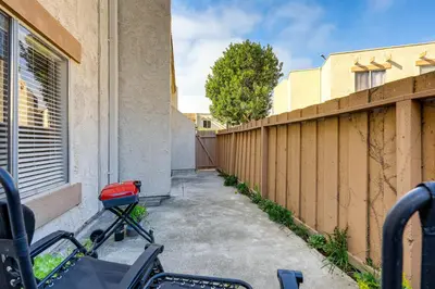 a bike parked next to a fence next to a building at 2 Mi to Beaches Condo with Patio in Port Hueneme! in Port Hueneme