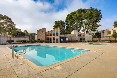 a swimming pool in front of a building at 2 Mi to Beaches Condo with Patio in Port Hueneme! in Port Hueneme