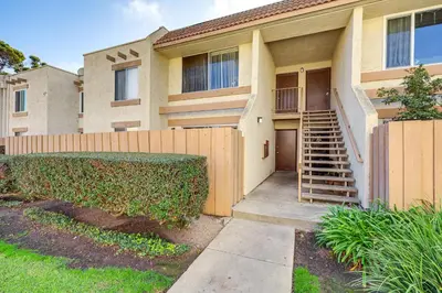a house with a fence and a staircase in front at 2 Mi to Beaches Condo with Patio in Port Hueneme! in Port Hueneme
