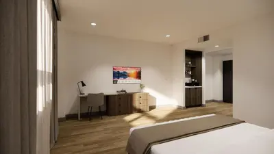 a bedroom with a bed and a desk at Kins Hotel in Los Angeles