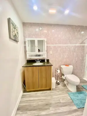 a bathroom with a white toilet and a sink and a toilet istg at 1BR Pink Cozy House near DTLA in Rosemead
