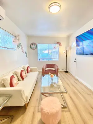 a living room with a white couch and a glass table at 1BR Pink Cozy House near DTLA in Rosemead