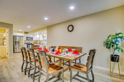 a kitchen and dining room with a table and chairs at 4 Mi to Lake Arrowhead Cabin with Grill and Deck! in Twin Peaks