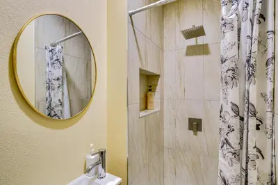 a bathroom with a shower and a sink and a mirror at 4 Mi to Lake Arrowhead Cabin with Grill and Deck! in Twin Peaks