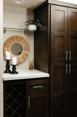 a bathroom with a wooden cabinet and a mirror at Signature One Bedroom Apartment in Los Angeles