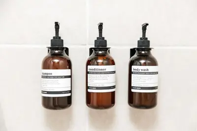 a group of three bottles of liquid on a wall at Signature One Bedroom Apartment in Los Angeles