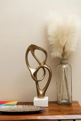 a glass vase with feathers in it next to a glass vase with at Signature One Bedroom Apartment in Los Angeles