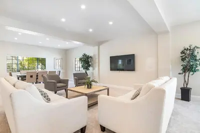 a living room with white furniture and a flat screen tv at Beautiful 6BR Family 2-Story Villa With Large Backyard and Outdoor Kitchen in Los Angeles