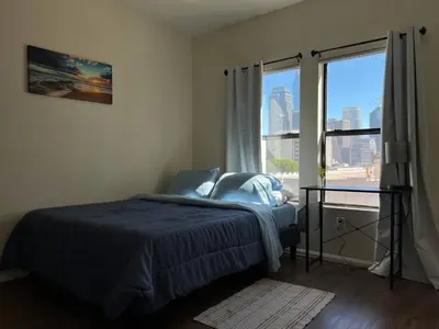 a bedroom with a bed and a large window at ELEGANT RESORT-SoCal-Lux on 3rd in Los Angeles