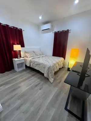 a bedroom with a bed and red curtains at Luxury mini house in Hughes-Canoga Park Heliport