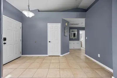 an empty living room with blue walls and a tile floor at 3 Bed 2 Bath Newly Furnished - Available Now in Bakersfield