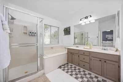a bathroom with a shower and a sink and a tub at 3 Bed 2 Bath Newly Furnished - Available Now in Bakersfield