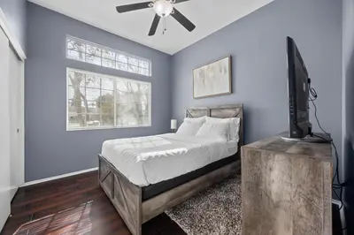 a bedroom with a bed and a ceiling fan at 3 Bed 2 Bath Newly Furnished - Available Now in Bakersfield