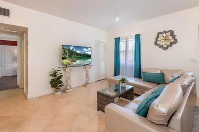 a living room with a couch and a table at Spacious 2BR Apartment with Full Kitchen & Dining In Beverly Hills in Los Angeles