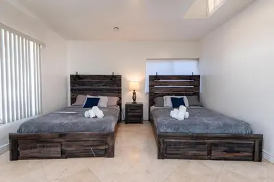 a bedroom with two beds with pillows on them at Spacious 2BR Apartment with Full Kitchen & Dining In Beverly Hills in Los Angeles