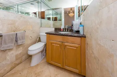 a bathroom with a toilet and a sink and a mirror at Spacious 2BR with Kitchenette and Dining in Beverly Hills in Los Angeles