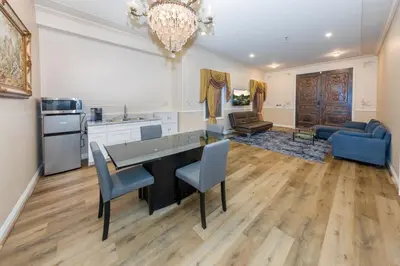 a kitchen and living room with a table and chairs at Spacious 2BR with Kitchenette and Dining in Beverly Hills in Los Angeles