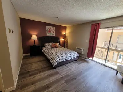 a bedroom with a bed and a large window at Beverly Hills Suite in Los Angeles