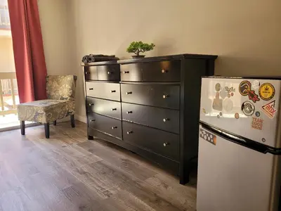 a dresser and a chest of drawers next to a refrigerator at Beverly Hills Suite in Los Angeles