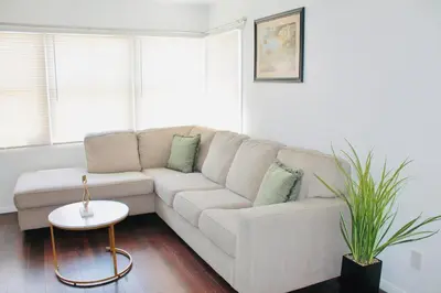 a white living room with a couch and a table at Los Angeles Red Rose in Monterey Park
